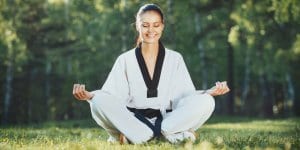 Martial Arts Lessons for Adults in Gilbert AZ - Happy Woman Meditated Sitting Background